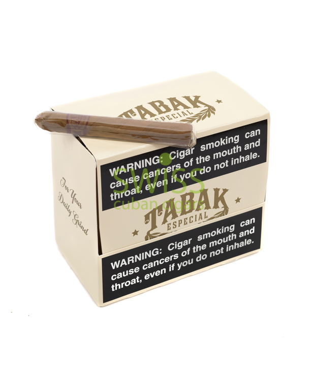 タバック・エスペシャルのクリーム色の縦長箱（閉）と濃茶マデューロのセロファン包装シガー。前面に黒い英語警告ラベル。側面に「For Your Daily Grind」。透かし。